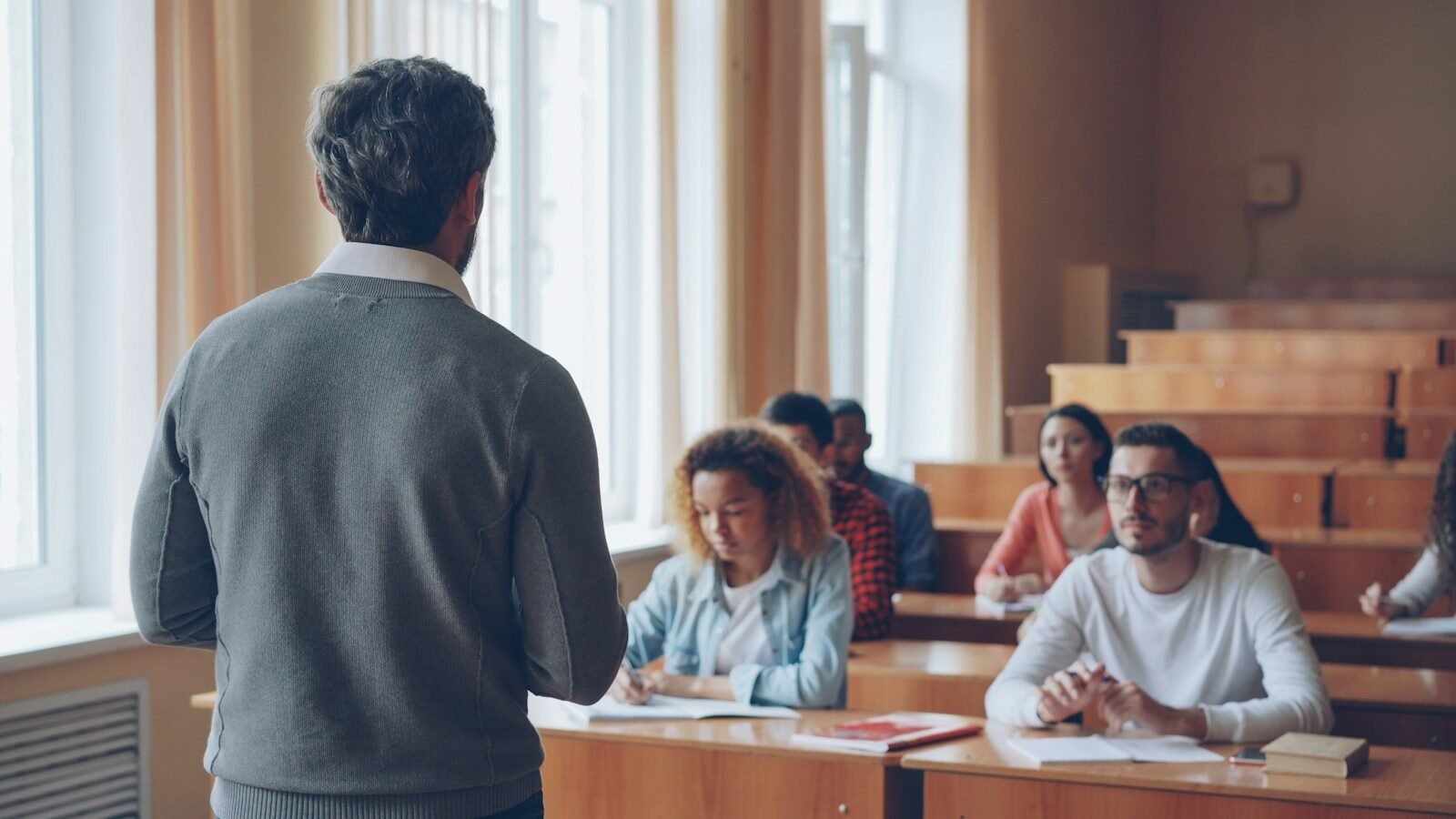 Professor teaching students in a lecture hall